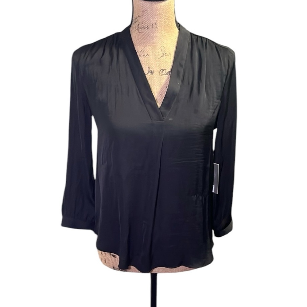 Vince Camuto black v- rock blouse with long sleeves with button accents.